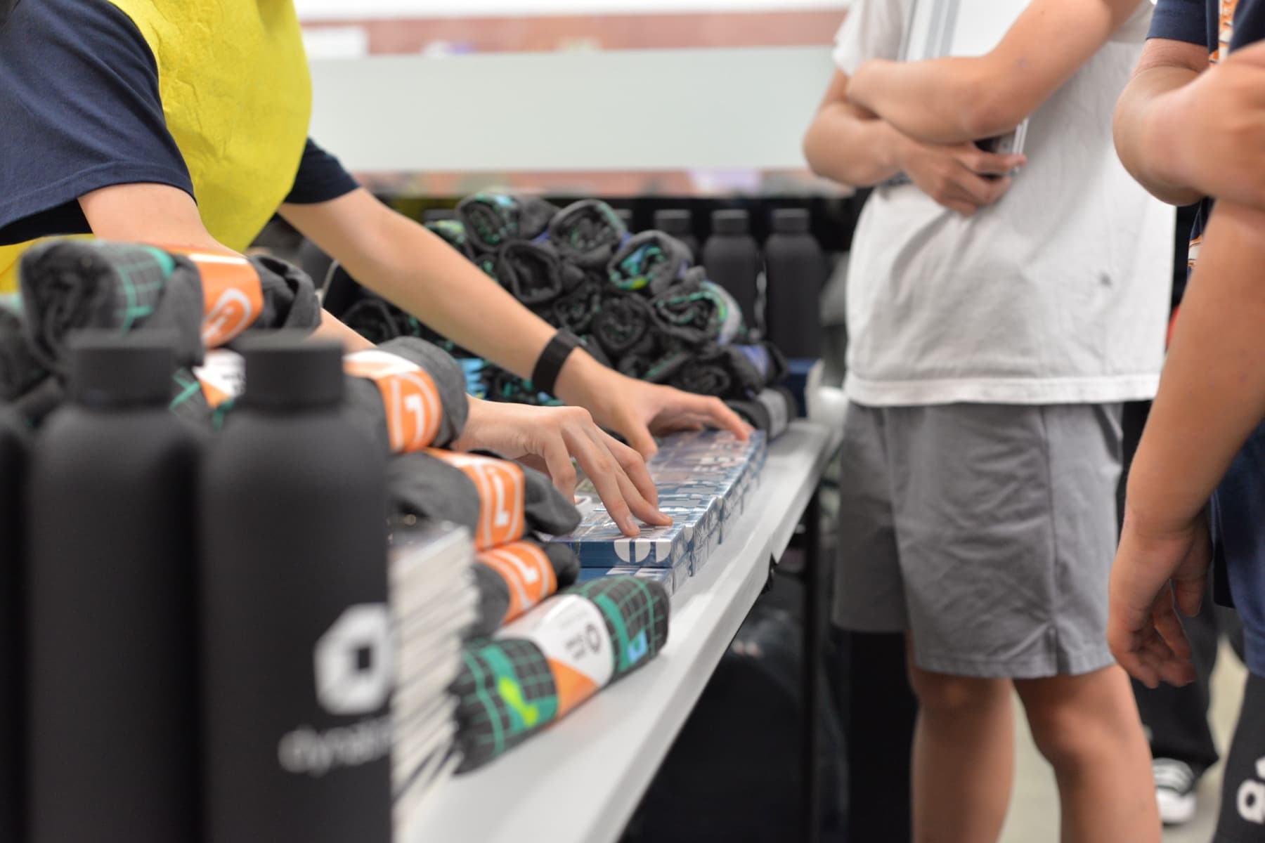 Teenagers choosing from a table of prizes and merchandise
